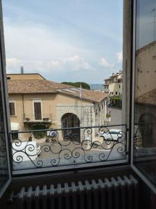 a view of a balcony from a window of a building at Appartamento palazzo del Provveditore vista lago in Desenzano del Garda