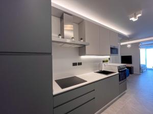 a kitchen with white cabinets and a counter top at Sliema Studios in Sliema