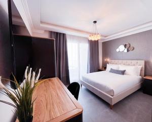 a hotel room with a bed and a table at Sliema Studios in Sliema