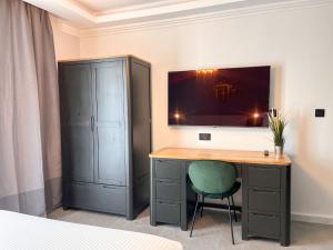 - une chambre avec un bureau et une chaise verte dans l'établissement Sliema Studios, à Sliema