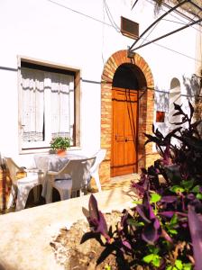 una sala da pranzo con tavolo e porta in legno di Arétta: appartamento nel cuore di Itri a Itri