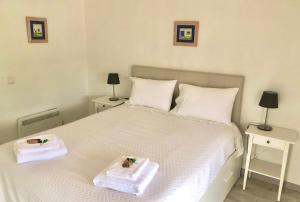 a bedroom with a white bed with two trays on it at Vinha da Quinta in Sintra