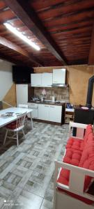a kitchen with white cabinets and a table and chairs at Ruralna kuća za odmor Pozojova hiža - Rural Holiday House in Lopatinec