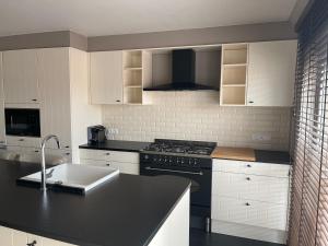 a kitchen with a sink and a stove top oven at -AYANA SUITE- 2 BEDROOM SUITE WITH GARAGE KNOKKE in Knokke-Heist