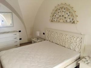 a bedroom with a white bed and a dresser at Modern Apartment in Gallipoli with Air Conditioning in Gallipoli