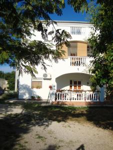 a white building with a balcony in front of it at Sea View Apartment in Zadar in Zadar