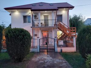 a house with a staircase in front of it at Casa Doros in Eforie Sud