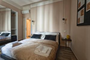 a bedroom with a large bed with towels on it at GOGO` Petit Hotel in Florence