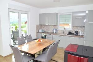 a kitchen with a wooden table and chairs at Apartman RIO in Jajce
