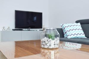 a vase filled with rocks on a coffee table in a living room at Apartman RIO in Jajce