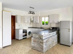 a kitchen with white appliances and a stone counter top at Your Go-to Place at Amwaj, North Coast for Summer! in El Alamein