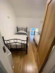 a hallway with two beds and a door to a room at Devane House in Portmagee