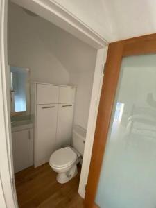 a small bathroom with a toilet and a sink at Devane House in Portmagee