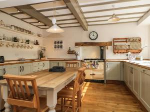 a large kitchen with a wooden table and chairs at The Old Post House in Grange Over Sands