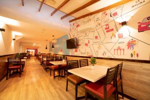 a restaurant with tables and chairs and a large wall at Centro by Casa Andina in Lima