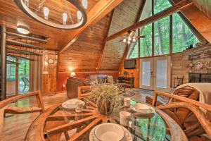 a dining room with a glass table in a cabin at A-Frame Gatlinburg Cabin with Deck and Private Hot Tub in Gatlinburg