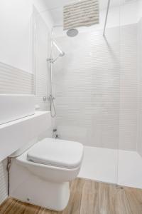 a white bathroom with a toilet and a shower at 3.2 Apartamento Coma Oriola in Puigcerdà