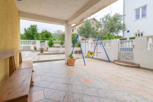 a porch with a swing and a bench at Apartments Punta in Kruševo