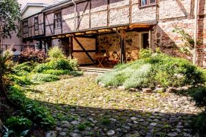 an old brick building with a walkway in front of it at Gildi Dolce Vita, Tartu Home in Tartu