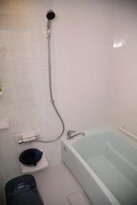 a bathroom with a bath tub and a shower at Guest room WES - Vacation STAY 54452v in Uruma