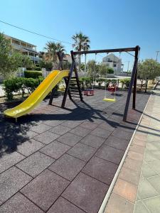 a playground with a slide in a park at Residence Doli in Vrsi