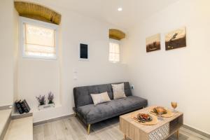 a living room with a couch and a table at Fontana Di Corfu 4 in Corfu Town