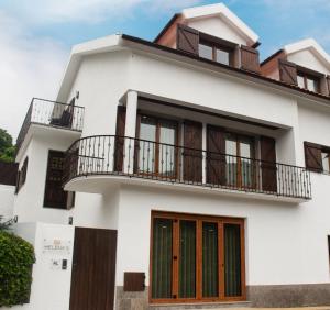 a white house with balconies on it at Helena's Family House in Pinhão