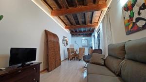 a living room with a couch and a flat screen tv at Casa Buzones in Toledo