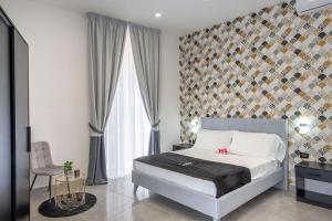 a bedroom with a bed and a large window at Red Queen Naples in Naples