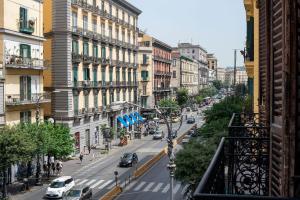 a view of a city street with cars and buildings at Red Queen Naples in Naples