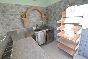 a small kitchen with a sink and a counter at Agriturismo le Fontane - Lago di Bolsena in Grotte di Castro