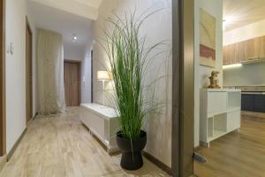 a living room with a plant in a pot at МareliS Luxe Port Apartment in Varna City +28 photos