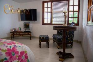 a living room with a table and a chair and a table at Casa Caballero Hotel Boutique in Salento +82 photos