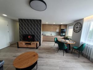 a living room with a table and a fireplace at 2-bedrooms apartment in city center Šiauliai in Šiauliai