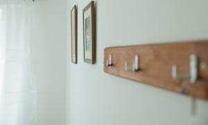 a row of picture frames hanging on a wall at Three Palms Apartments Novakovic in Petrovac na Moru