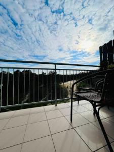 a balcony with a bench and a cloudy sky at Apartament z widokiem na wydmę in Ustka