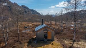 a small cabin in the middle of a forest at Unique cabin Sikringsbua in Sirdal in Tjørhom