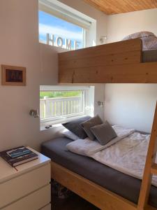 a bedroom with a bunk bed and a window at Nefsholt in Nefsholt