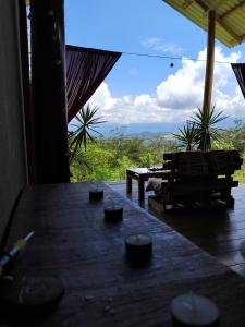 a large wooden table with a view of the mountains at Hacienda Monteclaro in Turrialba