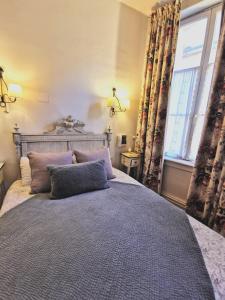 a bedroom with a bed with a large window at Hôtel de la Cathédrale Metz in Metz