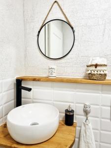 a bathroom with a white sink and a mirror at Apartment Kerbholz - zwischen Südschwarzwald und Schweiz in Klettgau
