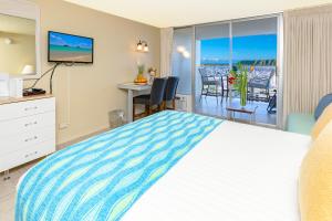 a bedroom with a bed and a view of the ocean at Ocean & Diamond Head View Studio at Waikiki in Honolulu +54 photos