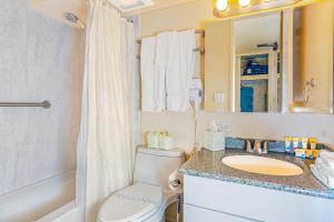 a bathroom with a toilet and a sink and a tub at Ocean & Diamond Head View Studio at Waikiki in Honolulu