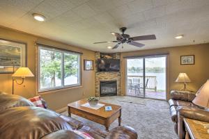 a living room with a couch and a fireplace at Big Fish Bay Hideaway - Rice Lake Home with Dock! in Rice Lake