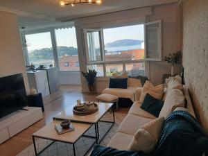 a living room with a couch and a table at Chalet en el centro de Baiona con vistas in Baiona
