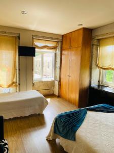 a bedroom with two beds and a window at Residencial Portas do Sol in Valença