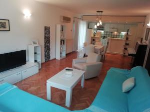 a living room with a couch and a table at Pine Apartment in Gevgelija