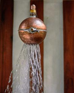 a close up of a bottle pouring water from a bird feeder at Kapok Bacalar - Plant Based Hotel in Buenavista