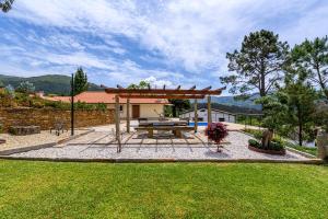 a patio with a picnic table in a yard at Escolinha de France in France