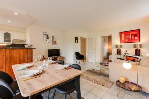 a dining room and living room with a table and chairs at The Parc des Raisses - T2 for 4 people in Annecy